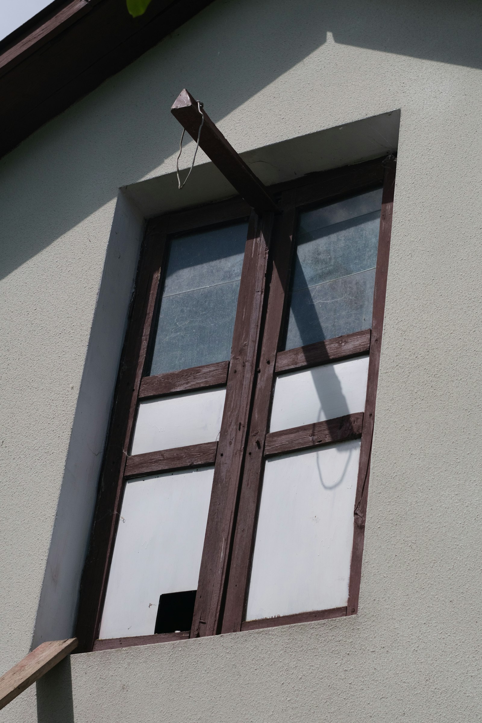 Contractor measuring a window frame for replacement window installation